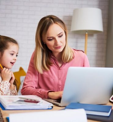 mother-working-with-little-daughter-home-interior_329181-19002